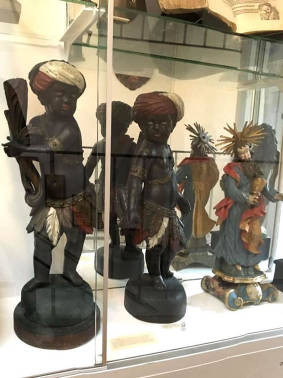 A group of statues in a glass case

Description automatically generated with low confidence